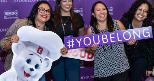 associates with an osito sign and a sign that says you belong